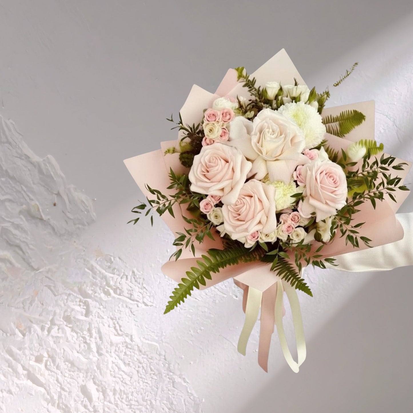 Blush reflexed roses from Bloomhaus Melbourne arranged as elegant floral bouquet, showcasing soft pink blooms and green foliage.