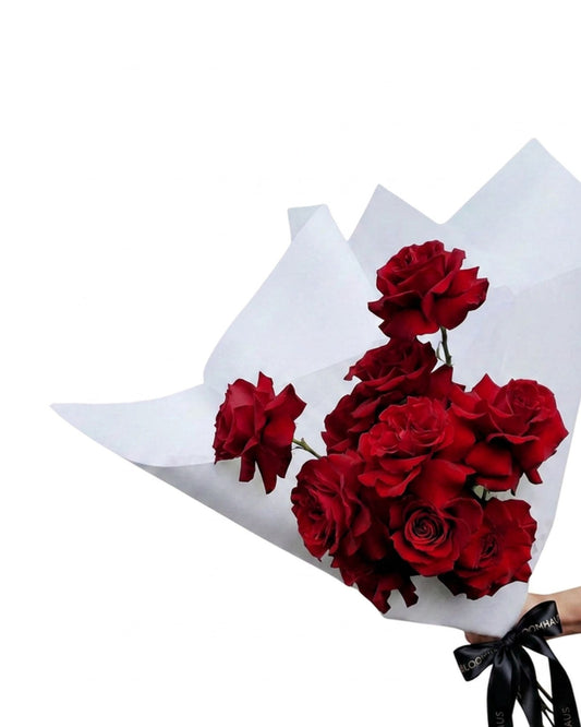 Ecuadorian roses en masse featuring vibrant reflexed roses with lush green foliage, arranged in a full floral display.