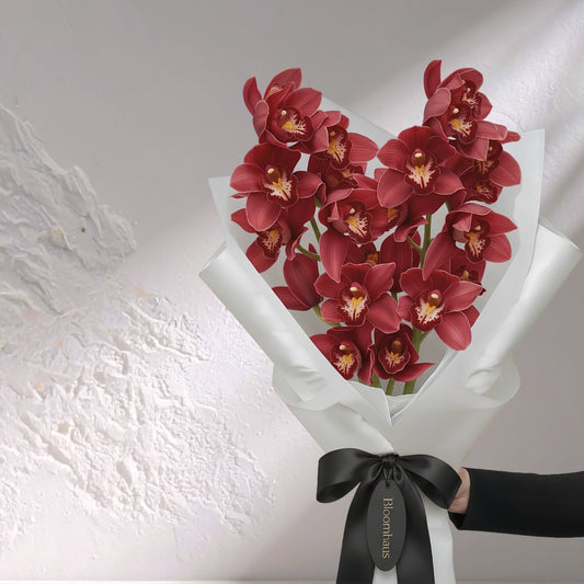Deep red Cymbidium orchid bouquet featuring multiple blooms, showcasing BLOOMHAUS MELBOURNE's elegant flower arrangement.