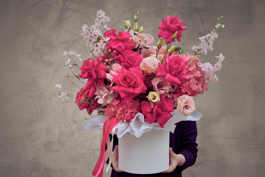 Fresh floral arrangement in a personalized hatbox labeled Carmen by Bloomhaus Melbourne Florist, featuring vibrant mixed flowers.