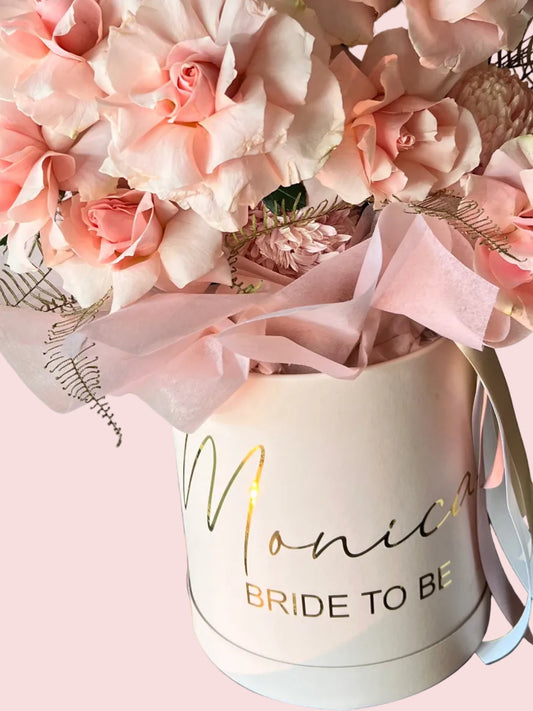 Personalized hatbox arrangement of fresh flowers by Bloomhaus Melbourne Florist in a stylish hatbox, featuring vibrant blooms and greenery.