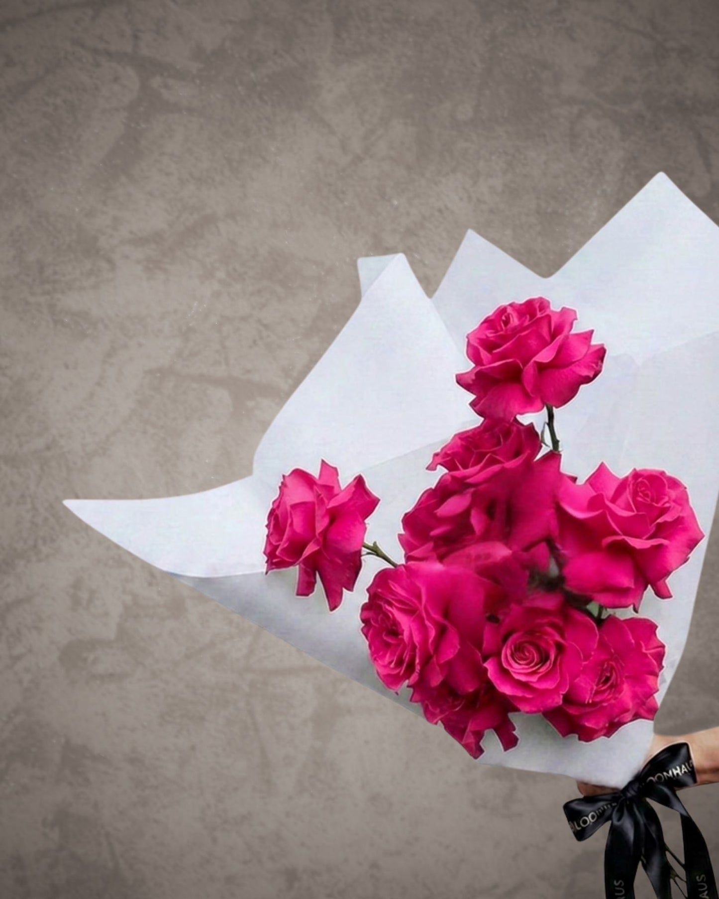 Ecuadorian reflexed roses in a bouquet with vibrant pink and red blooms, arranged in a natural floral display.