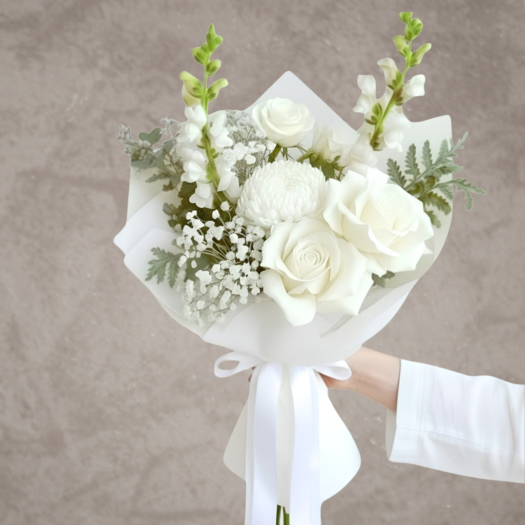 Close-up of BLOOMHAUS MELBOURNE Whisper roses, delicate pink flowers with lush green leaves, beautifully arranged.