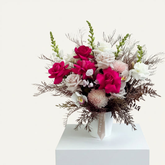 Bright pink rose flower arrangement by BLOOMHAUS MELBOURNE featuring seasonal blooms in a stylish pot.