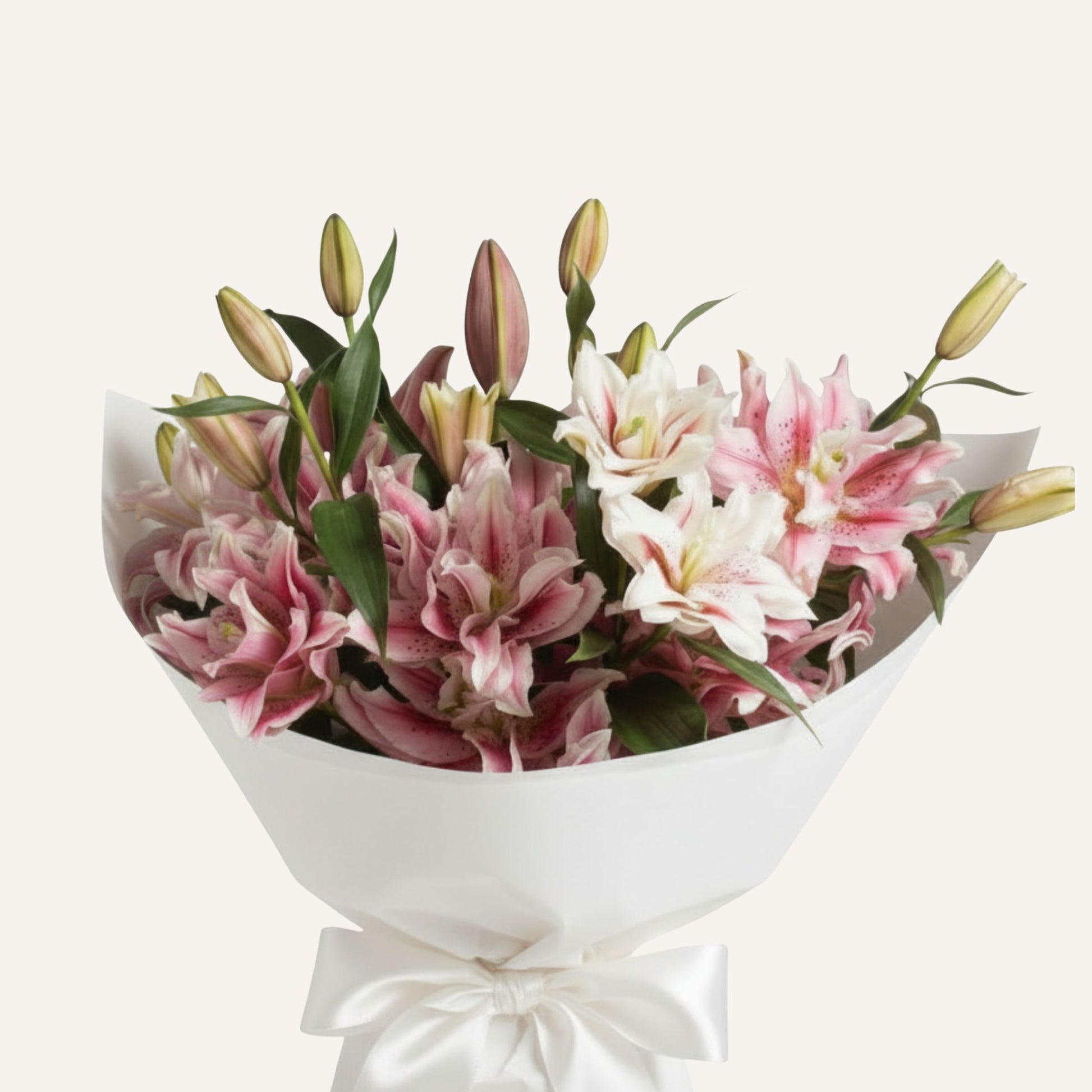 Pollen-free fragrant rose lilies arranged in a large bouquet, showcasing vibrant pink blooms and lush green leaves.
