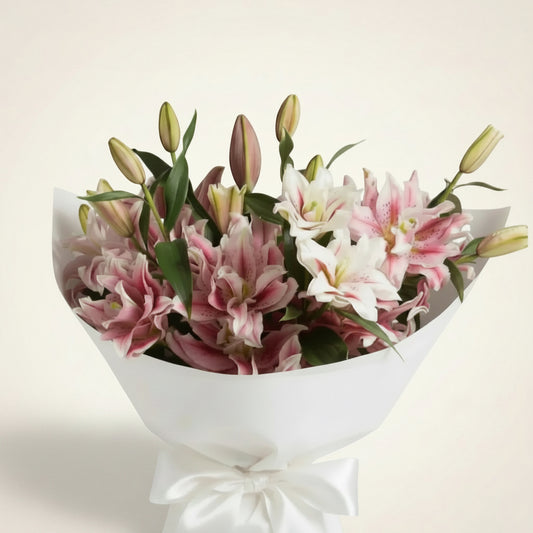 Pollen-free fragrant rose lilies arranged in a large bouquet, showcasing vibrant pink blooms and lush green leaves.