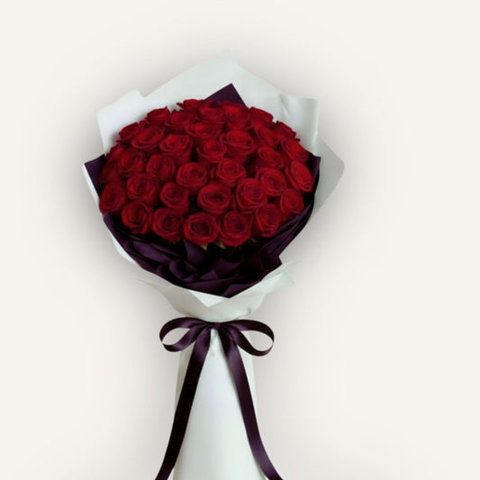 Long stem premium red rose bouquet by BLOOMHAUS MELBOURNE, featuring 12 vibrant roses arranged in a lush floral display.