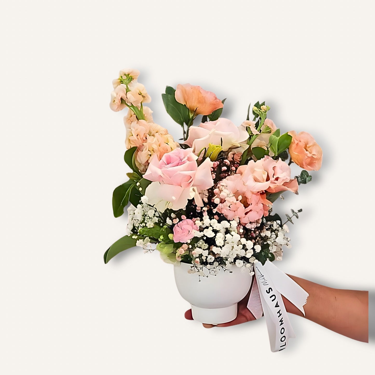 Reflexed pink roses and seasonal blooms in a ceramic pot, arranged by BLOOMHAUS MELBOURNE for a Pretty in Pink floral display.
