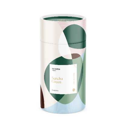 Mad Hatter Tea Sencha green tea bags, 25-count box, featuring vibrant green tea leaves in individual tea bags.