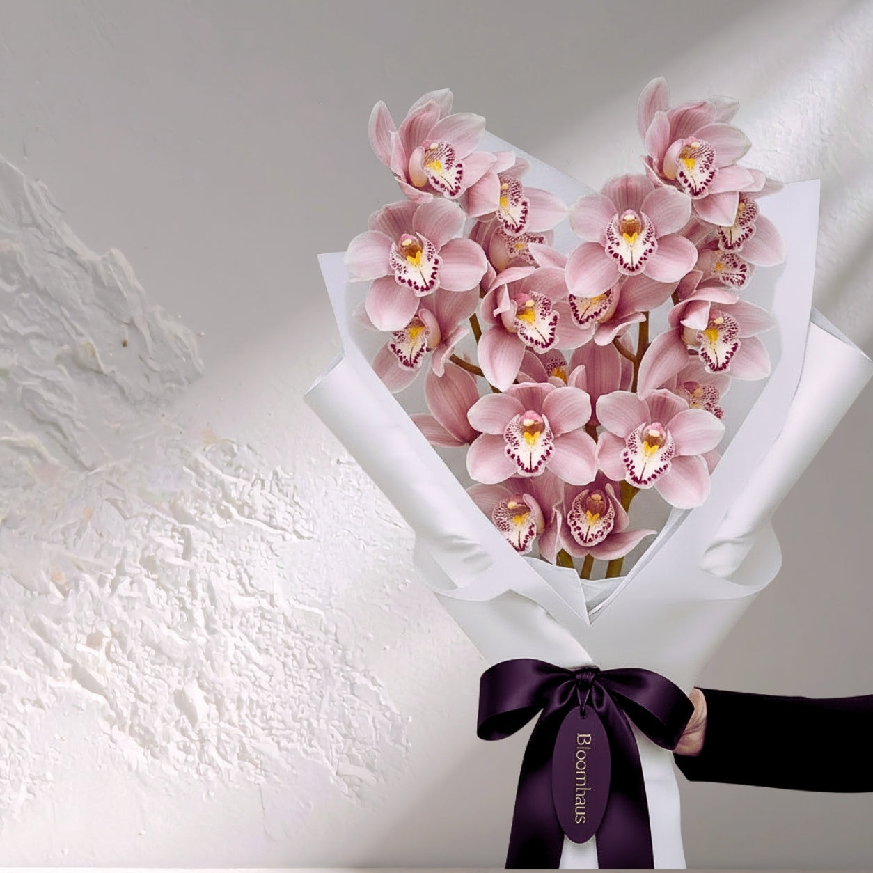 Pink Cymbidium orchid flowers from BLOOMHAUS MELBOURNE, showcasing vibrant blooms in a lush orchid arrangement.