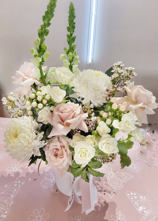 Angel| White and Blush reflexed roses with seasonal blooms and babies breath in a ceramic pot 